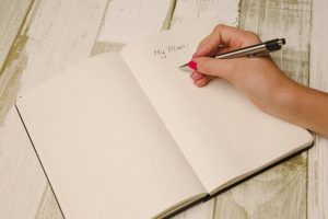 woman writing "my plan" in a journal